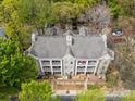 Birds-eye view of a multi-story building with a gray roof surrounded by mature trees and parking at 306 S Cedar St # 10, Charlotte, NC 28202