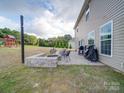Backyard patio with a fire pit, seating, grill, and outdoor entertainment space at 3810 New Salem Rd, Monroe, NC 28110