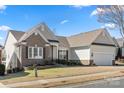 Charming single Gathering home with a brick and vinyl exterior, attached garage, and landscaped front yard at 39617 Rosebay Ct, Fort Mill, SC 29707