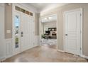 Bright and inviting foyer features tile flooring and an open view to a well-lit home office space at 39617 Rosebay Ct, Fort Mill, SC 29707