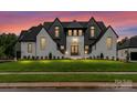 Stunning modern farmhouse with a manicured lawn, stylish black-and-white color scheme, and elegant front entrance at 406 Sugar Maple Ln, Weddington, NC 28104