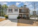 Attractive two-story home with stone and siding accents, complemented by a driveway and manicured front lawn at 428 Wheat Field Dr, Mount Holly, NC 28120