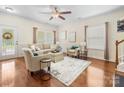Comfortable living room features hardwood floors, neutral paint, and an elegant ceiling fan at 4434 Patriots Hill Rd, Mint Hill, NC 28227