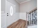 Bright foyer featuring wood flooring, decorative trim, and an elegant staircase with iron accents at 4731 Whispering Oaks Dr, Charlotte, NC 28213