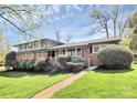 Charming two-story brick home with manicured lawn and lush landscaping at 501 Eastwood Dr, Gastonia, NC 28054