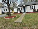 Well-maintained front yard with fresh landscaping, a walkway, and a view of the house at 609 Mccarten St, Monroe, NC 28112