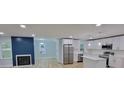 Open-concept living space featuring a fireplace, new appliances, and lots of natural light at 609 Mccarten St, Monroe, NC 28112