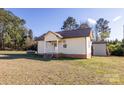 A single story home shows great curb appeal with a nice yard and storage shed at 6441 Highway 73 W Hwy, Mount Gilead, NC 27306
