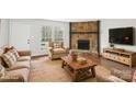 Inviting living room with a stone fireplace and stylish decor, creating a warm and cozy atmosphere at 6501 Thamesmead Ln, Mint Hill, NC 28227