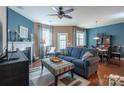 Comfortable living space featuring hardwood floors, a blue sofa, and a decorative fireplace at 7426 Calhoun Falls Dr, Rock Hill, SC 29732