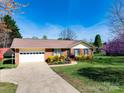 Lovely brick home with a charming front yard, long driveway, and attached garage at 841 E Zion Church Rd, Shelby, NC 28150