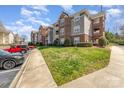 Inviting condo building exterior with lush lawns and convenient parking spaces at 9810 Campus Walk Ln # G, Charlotte, NC 28262
