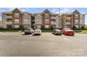 Beautiful condo building exterior with parking, brick accents, and well-maintained landscaping at 9810 Campus Walk Ln # G, Charlotte, NC 28262