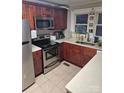 Efficient kitchen featuring stainless steel appliances and wood cabinets at 1011 Buick Ave, Kannapolis, NC 28083