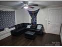 Inviting living room with a comfortable black leather sectional and natural light at 1011 Buick Ave, Kannapolis, NC 28083