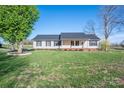 Charming single-story home featuring a well-manicured lawn and classic architectural details at 121 Wichita Dr, Shelby, NC 28152