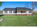 Well-maintained single-story home, accented by a covered entryway and a manicured lawn at 121 Wichita Dr, Shelby, NC 28152