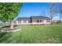 Inviting single-story home with a beautiful lawn and a classic front porch design at 121 Wichita Dr, Shelby, NC 28152