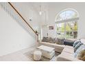 Bright living room with a large arched window, white walls, and a comfortable sectional sofa at 13521 Michael Lynn Rd, Charlotte, NC 28278