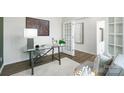 Cozy office showcasing a glass desk, modern chairs, and French doors with natural light at 140 Falling Up Ln, Salisbury, NC 28147