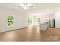 Open-concept kitchen area with stainless steel appliances, white cabinets, and light wood floors at 1530 Doran Ter, Richburg, SC 29729