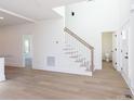 Open concept living room, features staircase, stylish flooring, and abundant natural light at 202 Westerwood Dr, Rock Hill, SC 29732