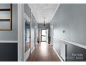 Hallway with doors, lighting fixture and hardwood floors at 203 Jackson St, Fort Mill, SC 29715