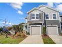 The exterior showcases a two-story gray home with a two-car garage and lovely front yard landscaping at 2365 Hedgecliff Rd, Kannapolis, NC 28025