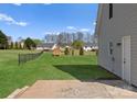 Spacious fenced backyard with a shed and neighboring homes in a serene community at 238 Lippard Springs Cir, Statesville, NC 28677