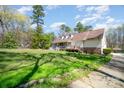 Well-maintained home with a spacious lawn and mature landscaping, offering a serene and private setting at 306 Nance Rd, Charlotte, NC 28214