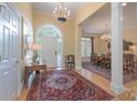 Bright foyer with hardwood floors, chandelier, and arched doorway leading to the dining room at 310 Berkeley Rd, Rock Hill, SC 29732
