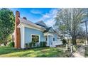 View of the home highlighting the blue siding and covered porch at 311 W Center Ave, Mooresville, NC 28115