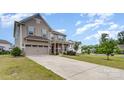 Two-story home with a front-facing two-car garage and a covered porch area surrounded by a lush lawn at 4630 Bent Green Ln, Monroe, NC 28112