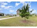 Two-story home on a corner lot with a well-manicured lawn and a young tree in the front yard at 4630 Bent Green Ln, Monroe, NC 28112