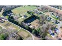 An aerial shot of a property with multiple outbuildings, a well-defined perimeter, and ample green space at 4875 Sulpher Springs Ne Rd, Hickory, NC 28601