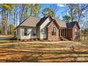 Well-maintained single-story home with brick and siding, manicured landscaping, and a walkway at 620 St Lukes Church Rd, Salisbury, NC 28146