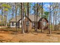Charming single-story brick home featuring a well-maintained lawn and mature trees at 620 St Lukes Church Rd, Salisbury, NC 28146