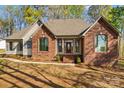 Charming brick home featuring a welcoming front porch, columns, and a landscaped walkway at 620 St Lukes Church Rd, Salisbury, NC 28146