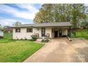 Cozy one-story home with a concrete driveway, inviting front porch, and charming curb appeal at 706 Annieline Dr, Shelby, NC 28152