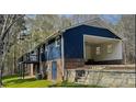 Rear view of home showcasing a cozy balcony, walkout basement, convenient carport, and brick and siding accents at 923 Wyke Rd, Shelby, NC 28150