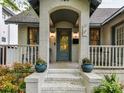 Inviting front porch with stylish door and potted plants, perfect for relaxing and enjoying the outdoors at 925 E 35Th St, Charlotte, NC 28205