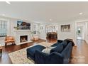 Spacious living room featuring a cozy fireplace, hardwood floors, and a comfortable blue couch at 925 E 35Th St, Charlotte, NC 28205