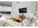 Spacious living area with TV, sectional sofa, leading to kitchen with bar seating at 925 Westmere Ave, Charlotte, NC 28208