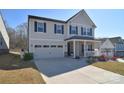 Charming two-story home with an attached garage and inviting front porch at 966 Scotch Meadows Loop, Monroe, NC 28110