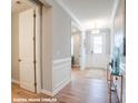 Elegant hallway with pristine trim work and a view of the well-lit front entrance at 9842 Quercus Ln, Huntersville, NC 28078