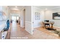 Inviting hallway with wood floors leading to a bright, modern office space at 9842 Quercus Ln, Huntersville, NC 28078
