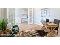 Stylish home office featuring a desk, jute rug, and ample natural light from French doors at 9842 Quercus Ln, Huntersville, NC 28078