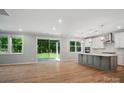 Open concept living space with modern kitchen, stainless appliances and sliding glass doors at 9957 Cask Way, Huntersville, NC 28078