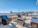Cozy backyard patio area with a fire pit and comfortable seating, ideal for outdoor gatherings at 12848 Mustang Dr, Midland, NC 28107