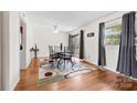 Open dining room with hardwood floors, a stylish table set, and a sliding door leading to an outdoor area at 1308 Gaston Way, Dallas, NC 28034
